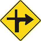 yellow diamond-shaped sign with black arrow that curves sharply right with a thinner line continuing upward and another branching to the left