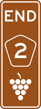 brown sign with the word end, a pentagonal route number badge and grapes icon