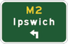 green sign with yellow M2, white arrow pointing up and left from the bottom and the word Ipswich