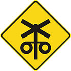 yellow diamond-shaped sign with black icon of a railway crossing sign and with 2 flashing lights