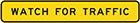 narrow yellow sign with black text, watch for traffic