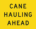 yellow sign with black text, cane hauling ahead