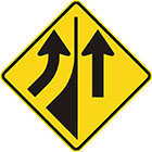 yellow diamond-shaped sign with a black arrow entering from the left and curving upward and another pointing upward with a divider between them