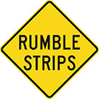 yellow diamond-shaped sign with black text, rumble strips