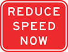 red sign with white text, reduce speed now