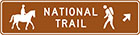 brown sign with icons of a person on a horse and a person hiking with the words national trail