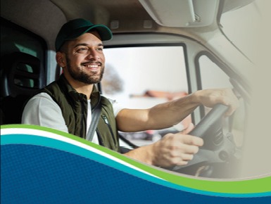 Young man behind the steering wheel smiling