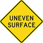 yellow diamond-shaped sign with black text, uneven surface