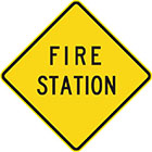 yellow diamond-shaped sign with black text, fire station