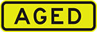 yellow sign with black text, aged