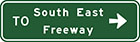 green sign with white arrow and text, to South East Freeway