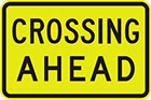 yellow sign with black text, crossing ahead