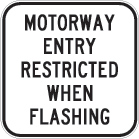 white sign with black text, motorway entry restricted when flashing