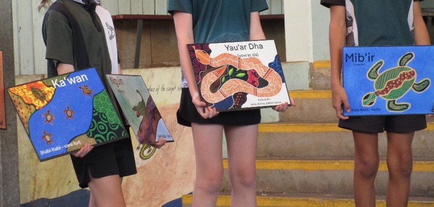 Caboolture State School students holding decorative Kabi Kabi artworks