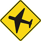 yellow diamond-shaped sign with black icon of an aeroplane