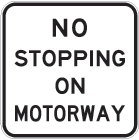 white sign with black text, no stopping on motorway