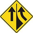 yellow diamond-shaped sign with a black arrow entering from the right and curving upward and another pointing upward with a divider between them