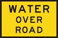 Image of a temporary sign that indicates there is water over a road ahead