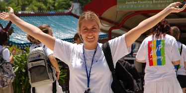 Smiling girl with arms outstretched.