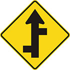 yellow diamond-shaped sign with straight black arrow with alternating branches off each side of the tail