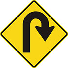 yellow diamond-shaped sign with black arrow that turns right into a u-shape