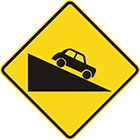 yellow diamond-shaped sign with black car facing down a slope