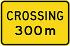 yellow sign with black text, crossing 300m