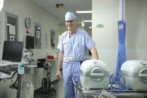 Photo of a surgeon with lifeport organ transportation boxes