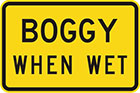 yellow sign with black text, boggy when wet