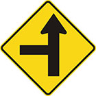 yellow diamond-shaped sign with straight black arrow with a straight branch leaving it at a right angle on the left