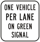 white sign with black text, one vehicle per lane on green signal