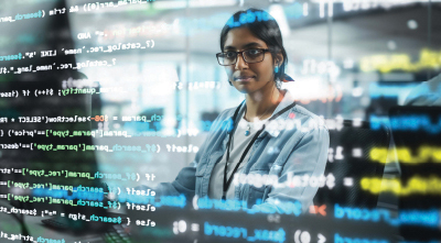 Young woman's face reflected in computer screen.