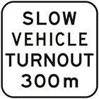 white sign with black text, slow vehicle turnout 300m