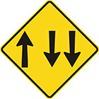 yellow diamond-shaped sign with 1 arrow pointing upward and 2 parallel arrows pointing downward