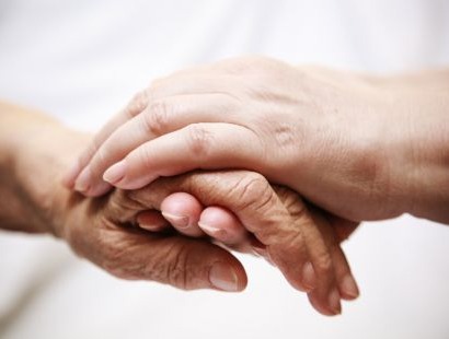 Close up photo of someone holding another persons hand