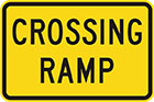 yellow sign with black text, crossing ramp