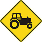 yellow diamond-shaped sign with black tractor icon