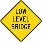 yellow diamond-shaped sign with black text, low level bridge