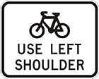 white sign with black icon of a bicycle and the words use left shoulder