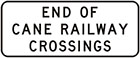 white sign with black text, end of cane railway crossings