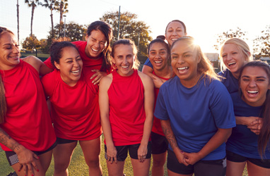 Sport team of children huddled together smiling at the camera