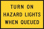 Sign saying Turn on hazard lights when queued