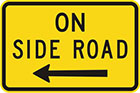 yellow sign with black arrow to left (or right) and text, on side road