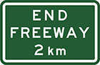 green sign with white text, end freeway 2km