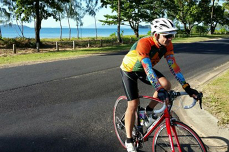 A person riding a bicycle on a public road.