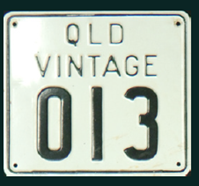 White background and black lettering and numbers on a rectangular vehicle registration plate