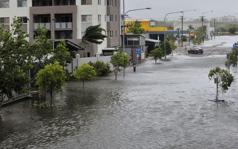 photo of a flooded street next to a building