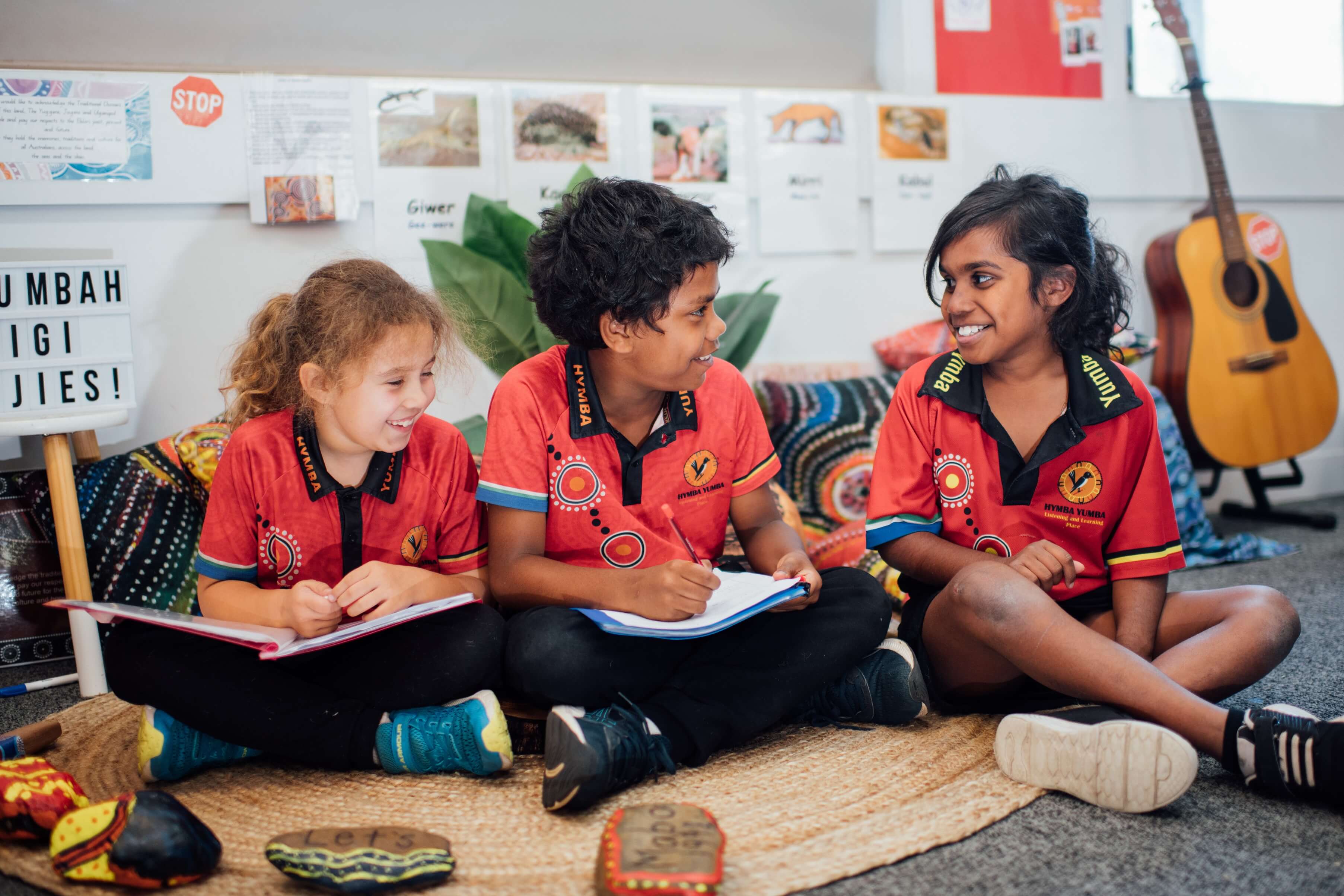 Hymba Yumba students sitting in a group reading and talking