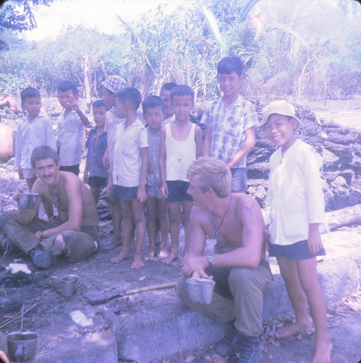 with kids during land clearing op around a village