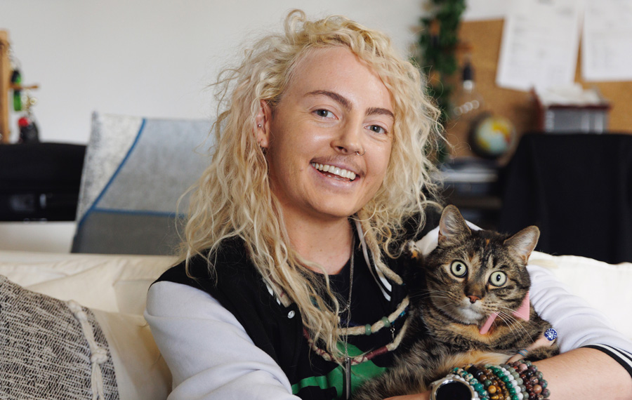 Person sitting on a couch holding a cat